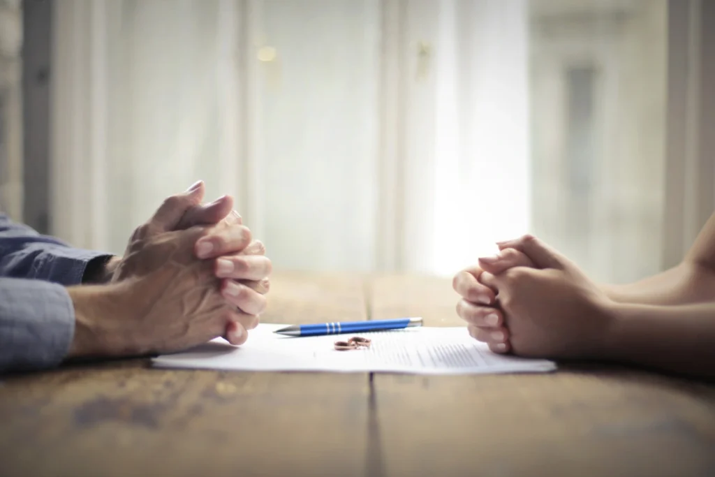 Dos anillos de boda separados sobre un documento de divorcio de mutuo acuerdo en Uruguay.